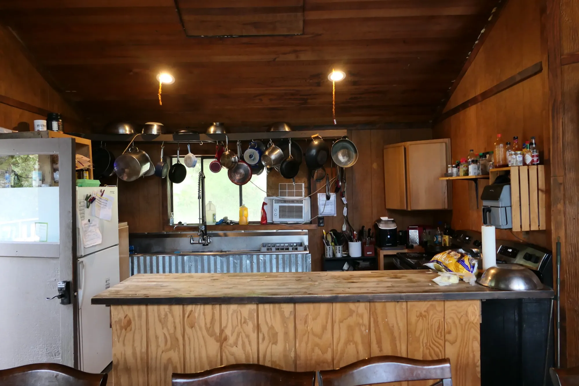 The lodge kitchen, with pots and pans hanging above the wood-clad island bar